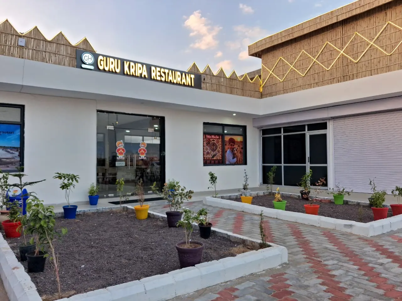 Guru Kripa Restaurant front garden at dusk, near HPCL Refinery, Pachpadra