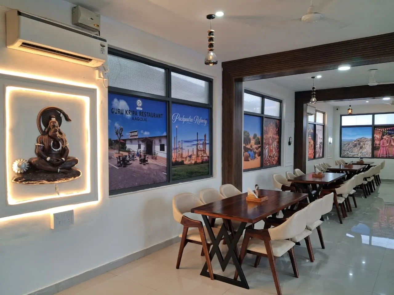 Backlit Shiva mural beside the dining tables at Guru Kripa